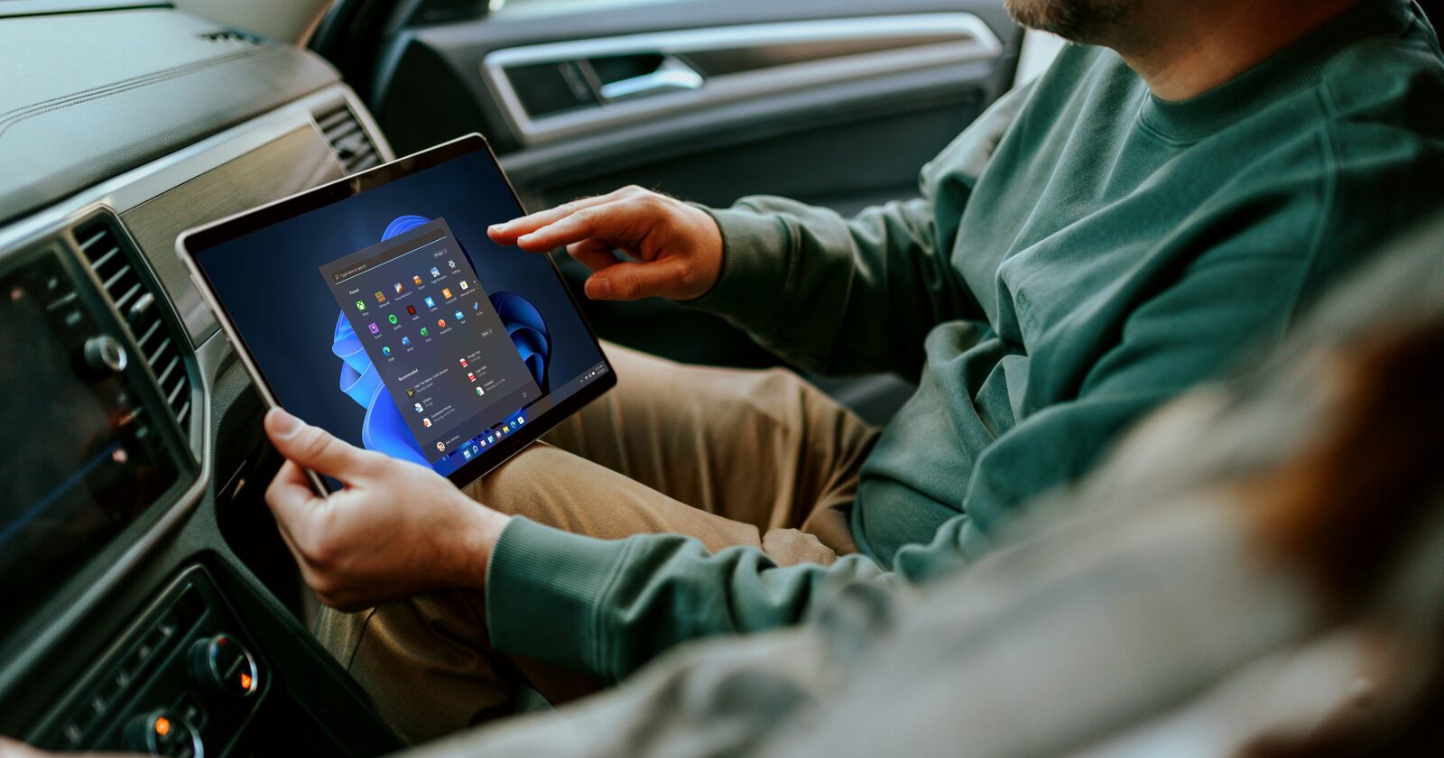 Rental operator reviewing fleet utilization data on a tablet in a vehicle